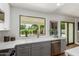 Bright kitchen featuring a large window, stainless steel appliances, and modern finishes at 5909 E Crocus Dr, Scottsdale, AZ 85254