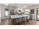 Modern kitchen featuring stainless steel appliances, a large island with seating, and stylish pendant lighting at 5909 E Crocus Dr, Scottsdale, AZ 85254