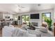 Bright and airy living room with a fireplace, modern furniture, and seamless flow to the kitchen at 5909 E Crocus Dr, Scottsdale, AZ 85254