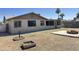 The backyard features a large grassy area, concrete pad, and custom fire pit area at 5924 W Tierra Buena Ln, Glendale, AZ 85306