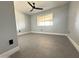 Bright bedroom featuring gray tile floors and a large window at 5924 W Tierra Buena Ln, Glendale, AZ 85306