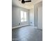 Bright bedroom featuring gray tile flooring, fresh paint, ceiling fan and a window at 5924 W Tierra Buena Ln, Glendale, AZ 85306