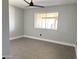 Bedroom featuring gray tile flooring, fresh paint, ceiling fan and a large picture window at 5924 W Tierra Buena Ln, Glendale, AZ 85306