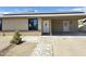 Charming single-story home featuring a solar-paneled roof and a welcoming front entrance with stone pathway at 5924 W Tierra Buena Ln, Glendale, AZ 85306