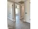 Hallway featuring white doors and trim and gray tile flooring at 5924 W Tierra Buena Ln, Glendale, AZ 85306