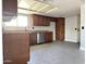 Spacious kitchen featuring tile floors, stainless steel appliances, and ample counter space at 5924 W Tierra Buena Ln, Glendale, AZ 85306