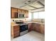Modern kitchen design featuring stainless steel appliances, granite counters and custom wood cabinets at 5924 W Tierra Buena Ln, Glendale, AZ 85306