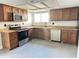 Well-appointed kitchen with stainless steel appliances, granite countertops, and custom cabinetry at 5924 W Tierra Buena Ln, Glendale, AZ 85306