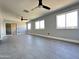 Large, open-concept living space with updated floors, lots of natural light, and dual ceiling fans at 5924 W Tierra Buena Ln, Glendale, AZ 85306