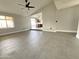 Spacious living room showcasing gray tile flooring, fresh paint, and an open floorplan at 5924 W Tierra Buena Ln, Glendale, AZ 85306