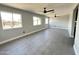 Bright living room featuring gray tile flooring, ceiling fans, and plenty of natural light at 5924 W Tierra Buena Ln, Glendale, AZ 85306