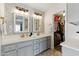 Chic bathroom with double sinks, decorative backsplash, modern fixtures, and access to a walk-in closet at 605 W Sandra Ter, Phoenix, AZ 85023