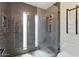 Modern bathroom with a glass-enclosed shower, stylish tile, and contemporary fixtures at 605 W Sandra Ter, Phoenix, AZ 85023