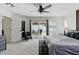Bright bedroom with a sliding door to the patio, ceiling fan, and neutral decor at 605 W Sandra Ter, Phoenix, AZ 85023