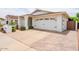 Well-maintained home features a two-car garage and neatly landscaped front yard at 605 W Sandra Ter, Phoenix, AZ 85023