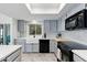 Bright kitchen with white countertops, light gray cabinets, stainless steel appliances, and backsplash at 605 W Sandra Ter, Phoenix, AZ 85023