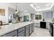 Bright kitchen with a large center island, gray cabinets, modern appliances, and stylish tile flooring at 605 W Sandra Ter, Phoenix, AZ 85023