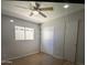Neutral bedroom features a window, tile floor and closet with sliding doors at 6111 N 64Th Dr, Glendale, AZ 85301