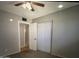Bedroom featuring a ceiling fan, carpeting, and closet with sliding doors at 6111 N 64Th Dr, Glendale, AZ 85301