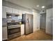 Bright kitchen featuring stainless steel appliances, white cabinets, and tile flooring at 6111 N 64Th Dr, Glendale, AZ 85301