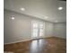 Spacious living room featuring tile flooring and a patio door leading to the backyard at 6111 N 64Th Dr, Glendale, AZ 85301