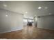 Open concept living space featuring tile flooring and a dining area with kitchen beyond at 6111 N 64Th Dr, Glendale, AZ 85301