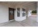 Comfortable back porch with a glass paneled entry door and white columns at 619 N Norfolk --, Mesa, AZ 85205