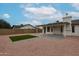 Spacious backyard featuring artificial turf, a covered patio, and gravel landscaping at 619 N Norfolk --, Mesa, AZ 85205