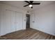 Bright bedroom with modern flooring, closet, and doorway leading to a bathroom at 619 N Norfolk --, Mesa, AZ 85205