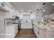Well-lit kitchen boasts stainless steel appliances and white cabinetry at 619 N Norfolk --, Mesa, AZ 85205