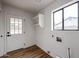 Clean laundry room with a window, door, and wall-mounted shelving at 619 N Norfolk --, Mesa, AZ 85205