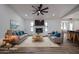 Bright living room with brick fireplace, ceiling fan, and modern furnishings at 619 N Norfolk --, Mesa, AZ 85205