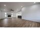 Spacious living room with a fireplace, fan, and wood-look floors at 619 N Norfolk --, Mesa, AZ 85205