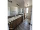 Bathroom with double vanity, granite countertop, and wood-look tile floors at 625 W Mckellips Rd # 111, Mesa, AZ 85201