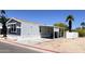 Manufactured home featuring an attached awning, blue and gray siding, and a gravel yard at 625 W Mckellips Rd # 111, Mesa, AZ 85201