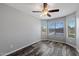 This bedroom features wood-look floors, a ceiling fan, and sunny windows at 6610 E University Dr # 165, Mesa, AZ 85205