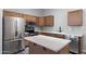 Modern kitchen featuring stainless steel appliances, wood cabinets, and ample counter space at 6610 E University Dr # 165, Mesa, AZ 85205