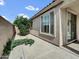 Yard with concrete ground, a small shrub, a large window, and a sliding glass door at 6752 W Citrus Way, Glendale, AZ 85303