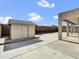 Spacious backyard featuring a storage shed, covered patio, and concrete flooring at 6752 W Citrus Way, Glendale, AZ 85303