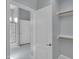 Bright bathroom showcases a glass shower, a white door, and open closet shelving at 6752 W Citrus Way, Glendale, AZ 85303