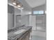Updated bathroom features a granite countertop vanity, shower with glass doors, and gray tile flooring at 6752 W Citrus Way, Glendale, AZ 85303