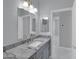 Bathroom featuring a gray vanity, granite countertop, brushed nickel faucet, and marble floors at 6752 W Citrus Way, Glendale, AZ 85303