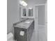 Bathroom featuring a gray vanity, granite countertop, brushed nickel faucet, and marble floors at 6752 W Citrus Way, Glendale, AZ 85303