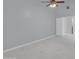 Bright bedroom features a ceiling fan and light gray walls and flooring at 6752 W Citrus Way, Glendale, AZ 85303