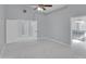 Spacious bedroom with ceiling fan, light gray walls and floors, and an ensuite bathroom at 6752 W Citrus Way, Glendale, AZ 85303