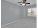 Bedroom with gray walls, marble floors, ceiling fan, and natural light from a window with blinds at 6752 W Citrus Way, Glendale, AZ 85303