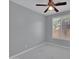 Minimalist bedroom featuring modern ceiling fan, window with white blinds, and marble tile at 6752 W Citrus Way, Glendale, AZ 85303