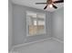 Neutral bedroom with ceiling fan, window with white blinds, and bright marble tiled flooring at 6752 W Citrus Way, Glendale, AZ 85303