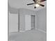 Bedroom with gray walls, marble floors, ceiling fan, closet, and two white doors at 6752 W Citrus Way, Glendale, AZ 85303