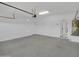 Clean garage featuring a water heater, doorway and door to the home's interior at 6752 W Citrus Way, Glendale, AZ 85303